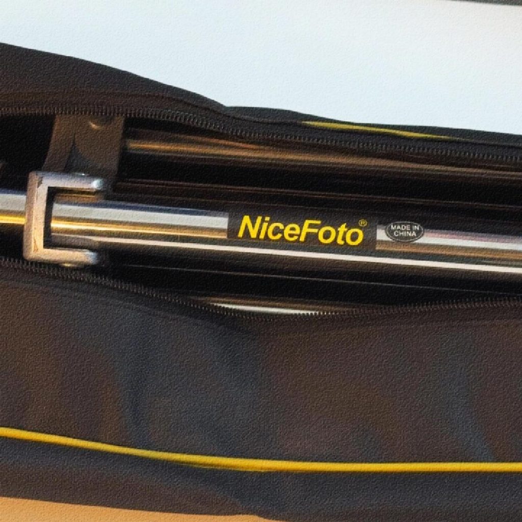 "Close-up of Nicefoto product packaging being opened to reveal professional photography equipment inside."